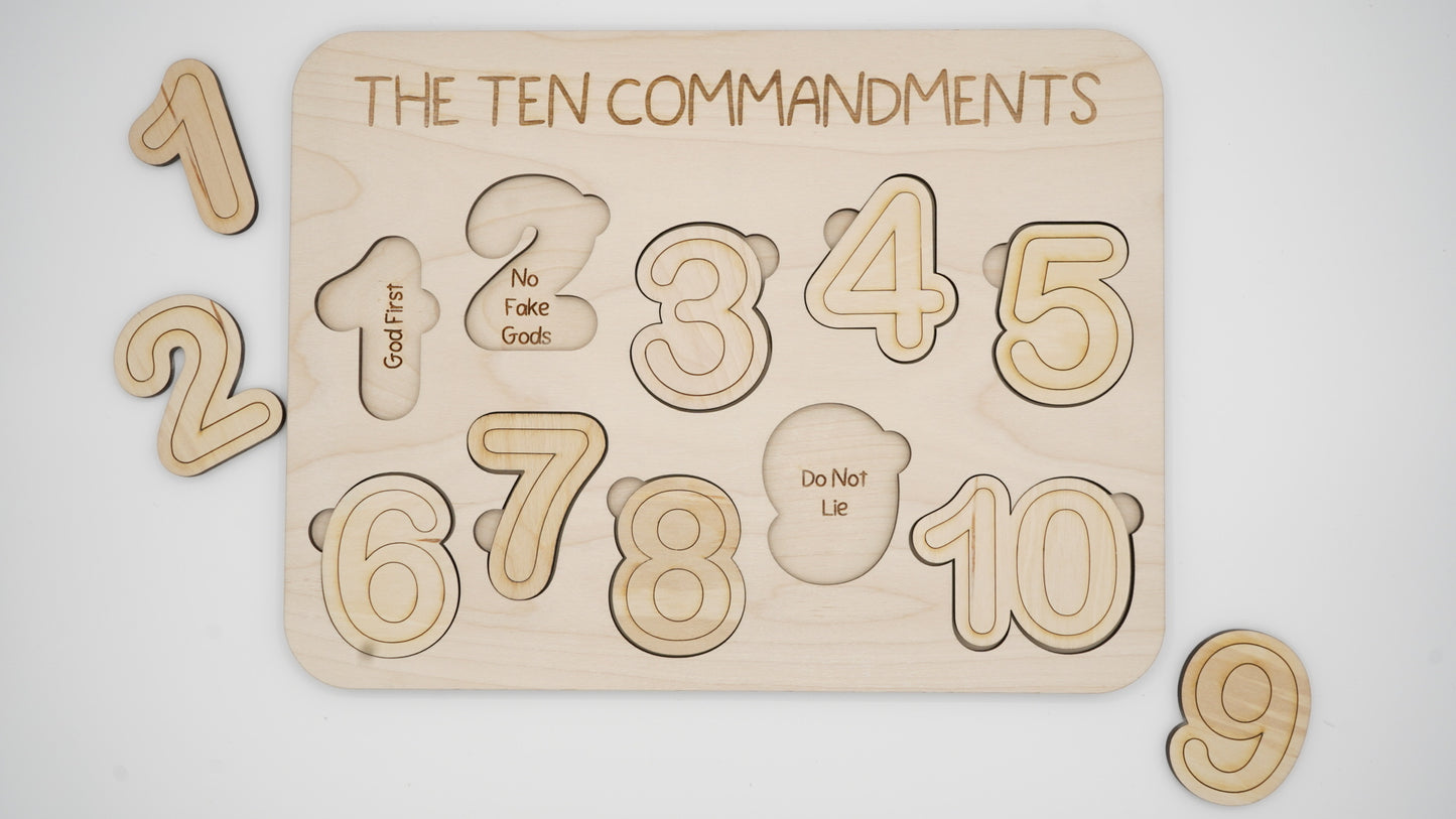 Wooden puzzle with 'The Ten Commandments' puzzle pieces in number shapes.