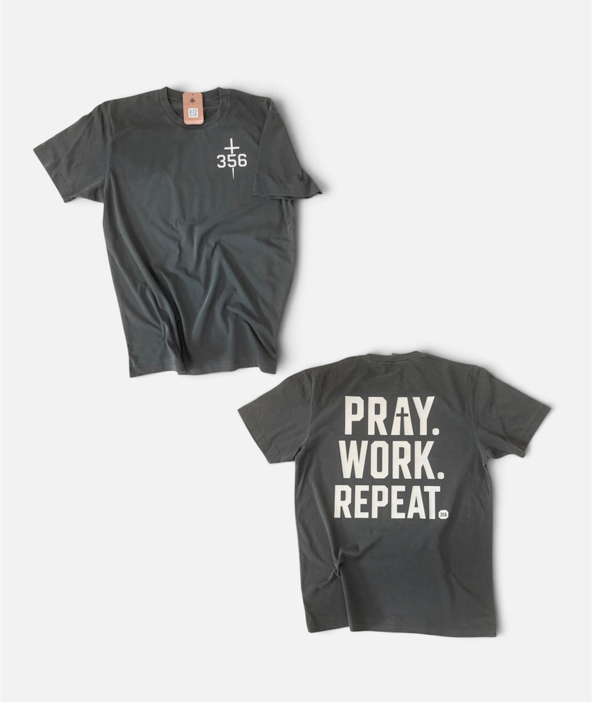 Two views of a dark gray crewneck t-shirt on a light gray background. The top view shows a small white cross and '356' printed on the left chest.
