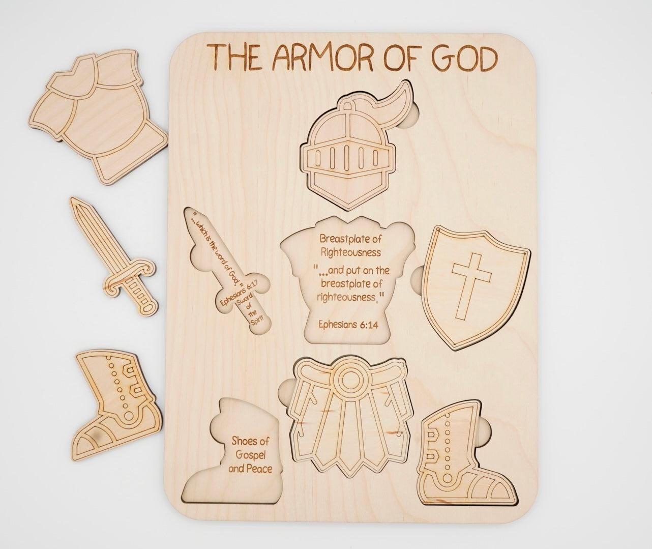 Wooden armor of God puzzle set laser engraved pieces of the suit of armor. Underneath the pieces is a description of the piece of armor.
