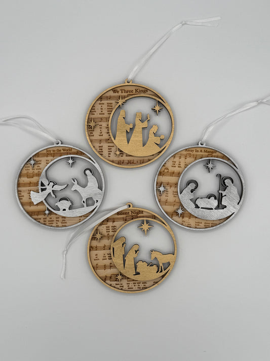 Four decorative circular wooden ornaments with that feature bible hymns engraved in the background and either a silver of gold bible scene on top.