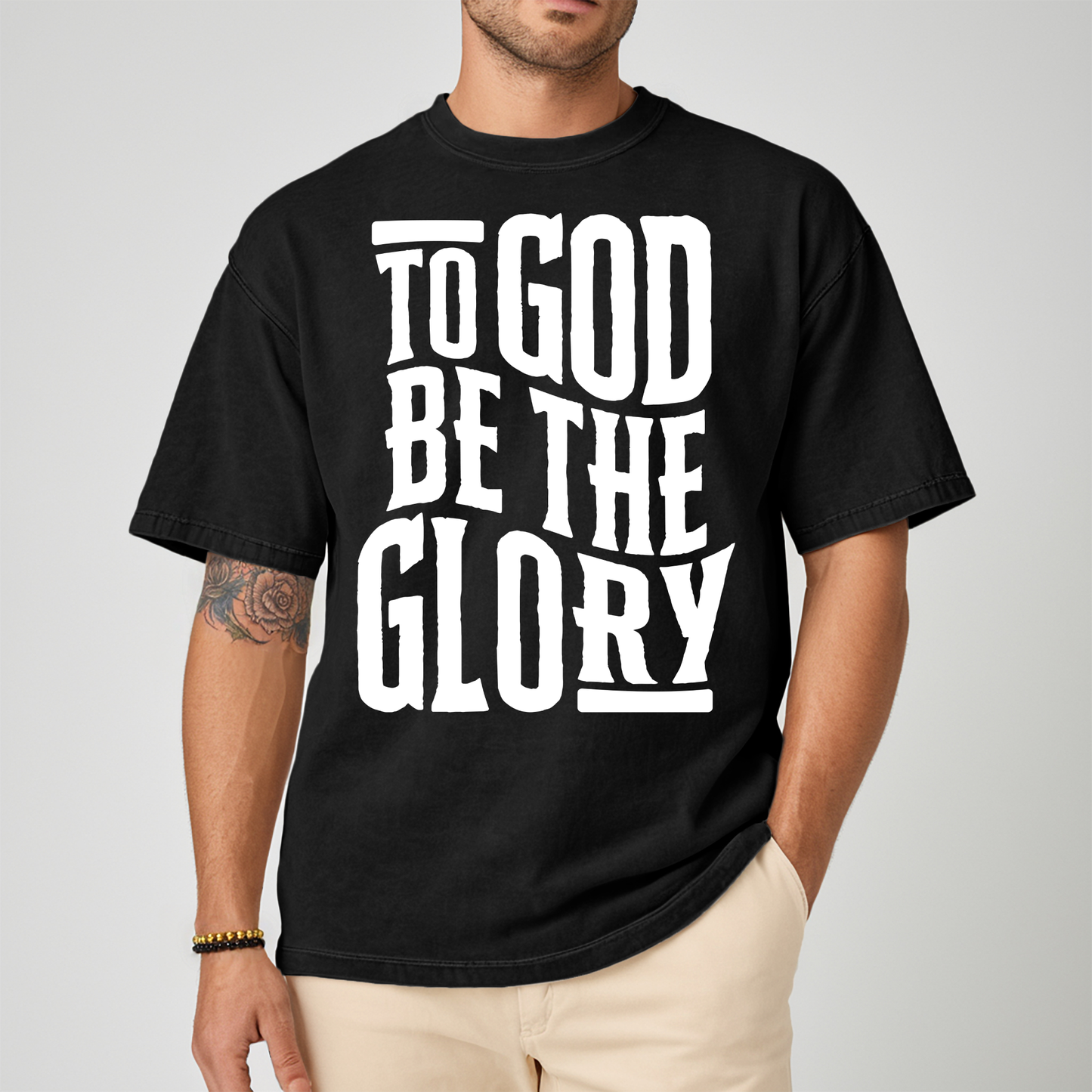Male wearing a black tshirt with white text about glory