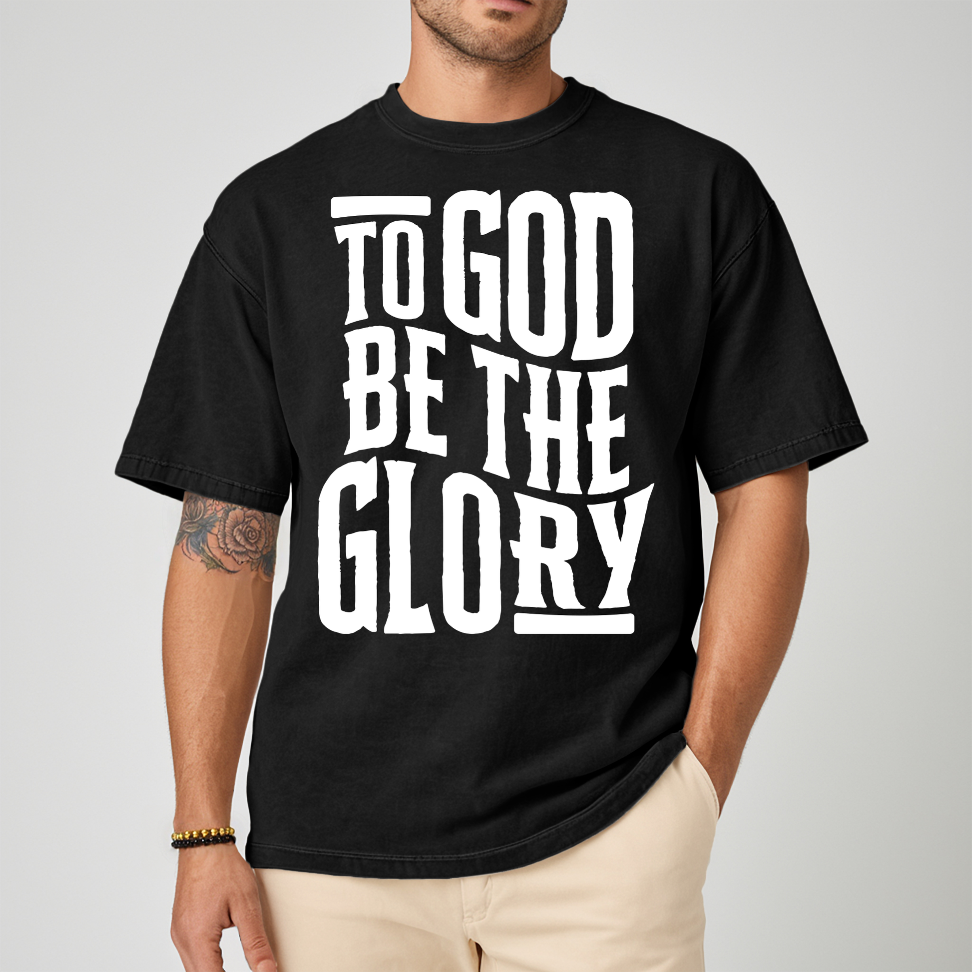 Male wearing a black tshirt with white text about glory