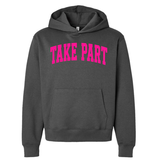 A dark gray pullover hoodie with the words 'TAKE PART' printed in bright pink arched block letters across the chest, displayed on a solid white background.
