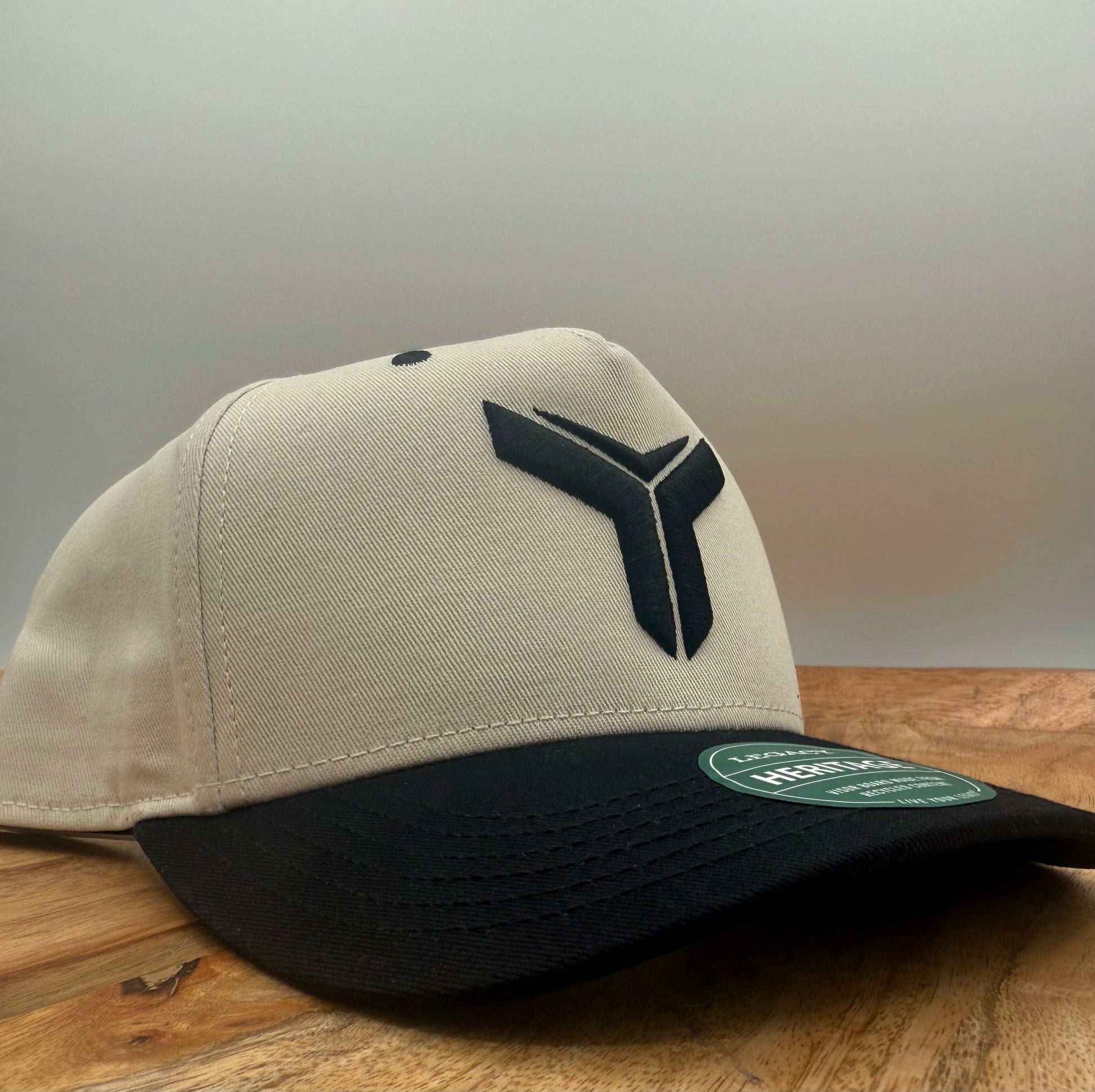 Beige and black two tone hat with Yoked logo embroidered in black