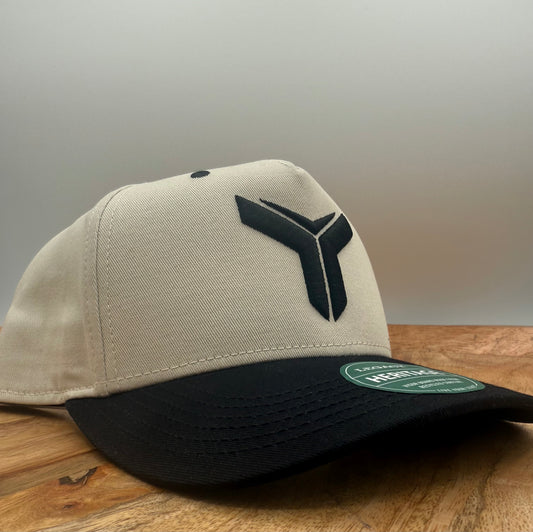 Beige and black two tone hat with Yoked logo embroidered in black