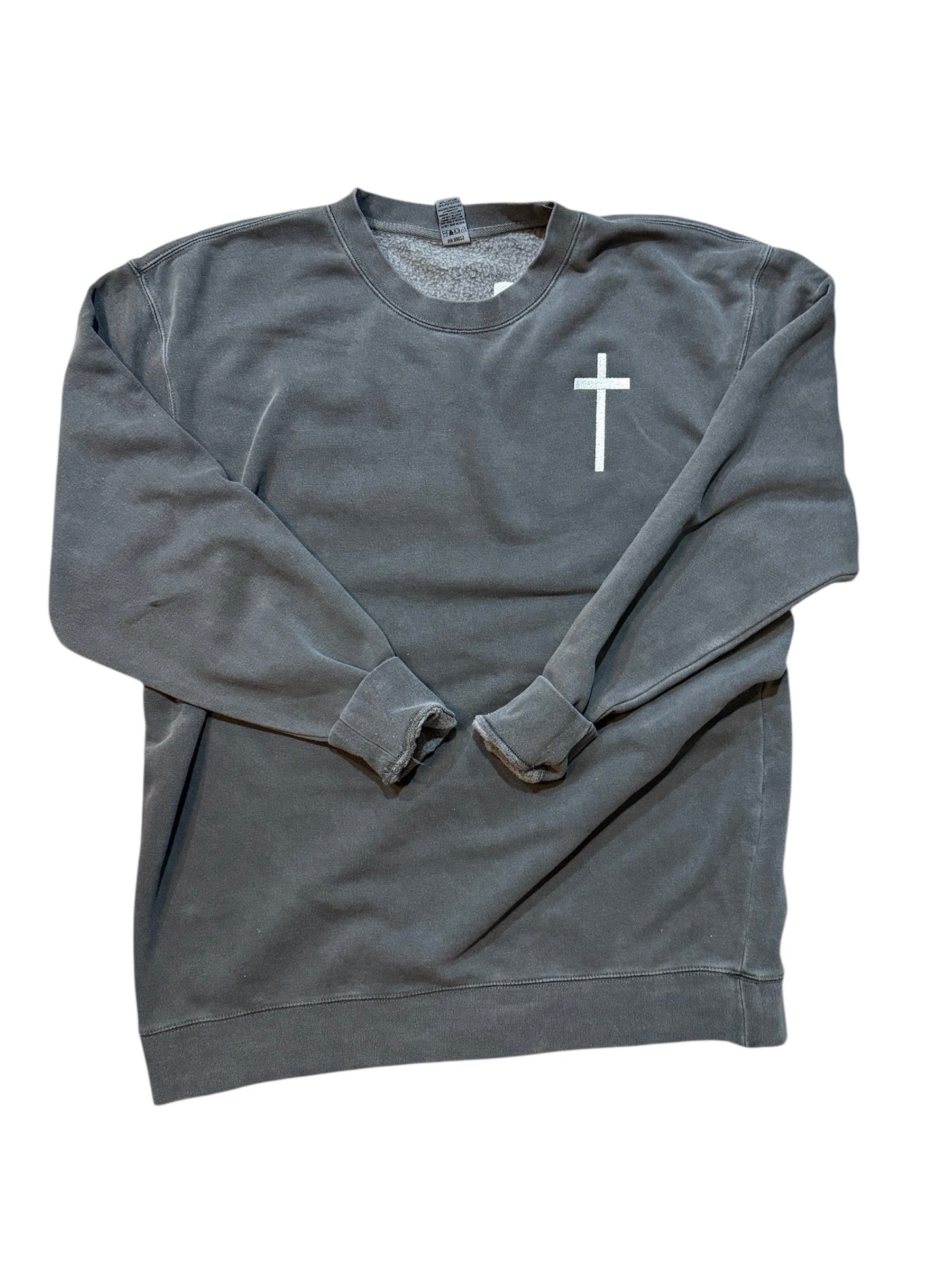 Front full view of gray sweatshirt with a cross on the front embroidered arms folded on a white background.
