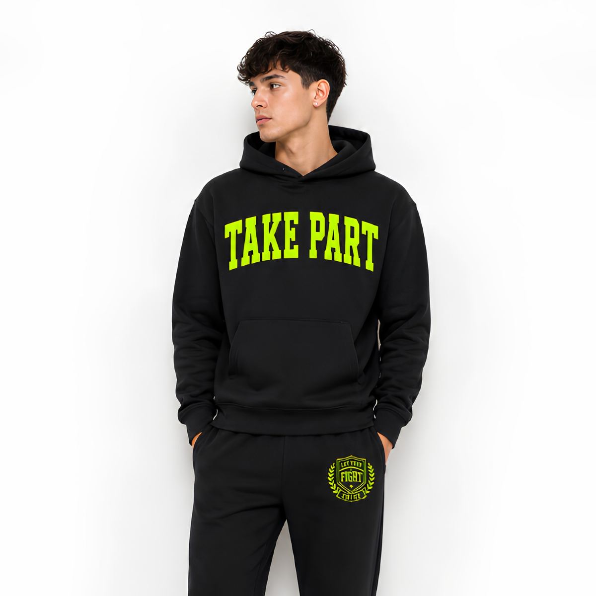 Man wearing a black and green take part hoodie and sweatpants