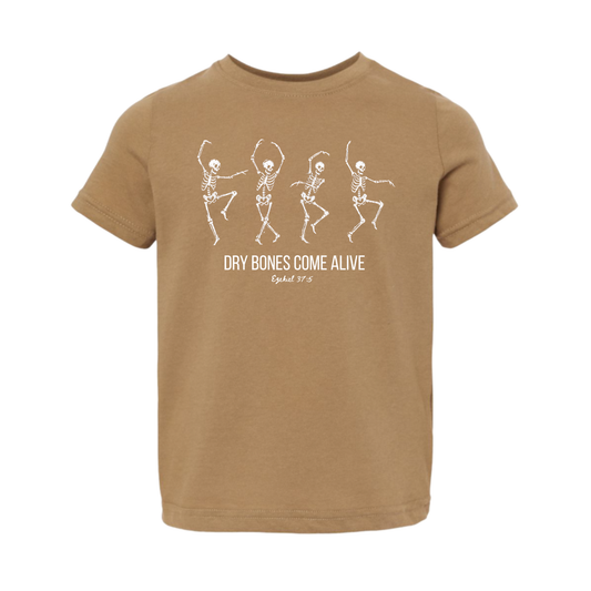 A tan crewneck t-shirt featuring a white graphic of four dancing skeletons and the text 'DRY BONES COME ALIVE' with 'Ephesians 3:15' printed below, shown against a plain white background.