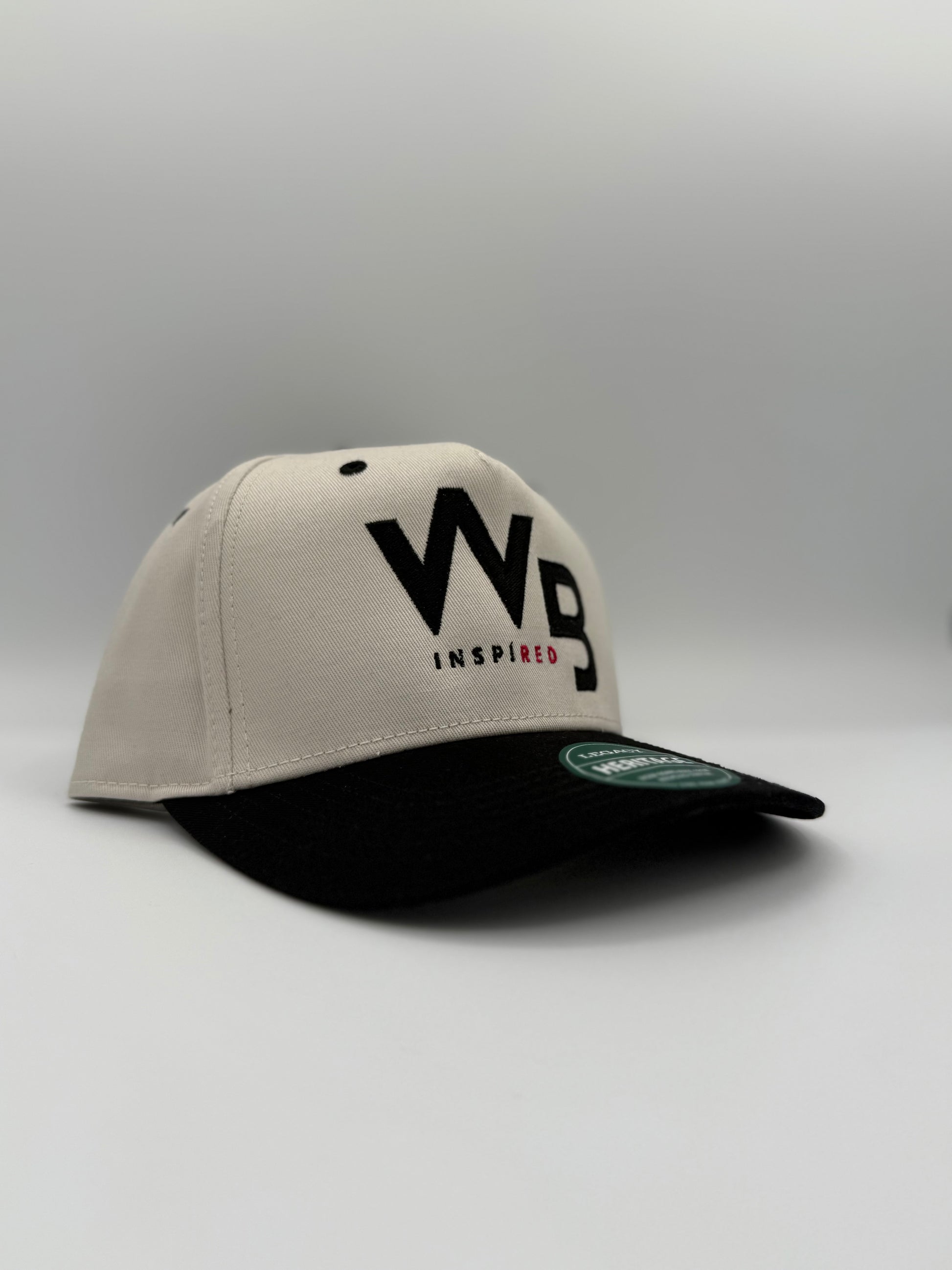 Beige and black cap with 'WB Inspired' logo on a gray background