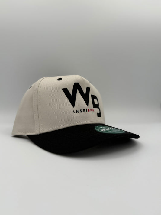 Beige and black cap with 'WB Inspired' logo on a gray background