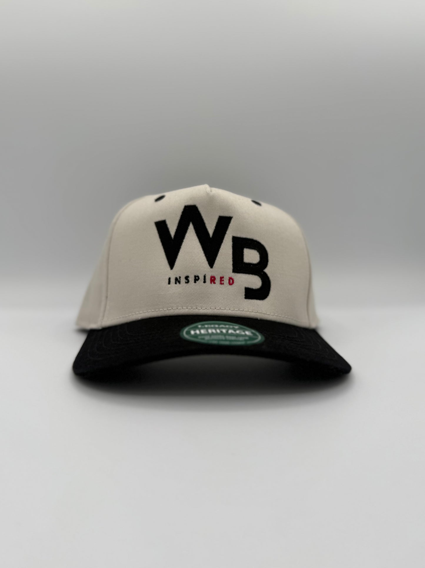 Beige and black cap with 'WB Inspired' text on a white background